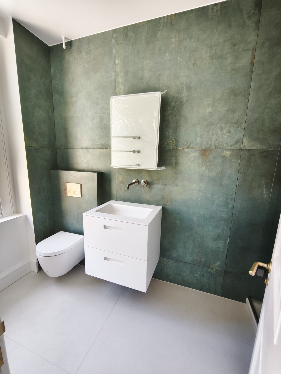 Finished green large-format porcelain bathroom