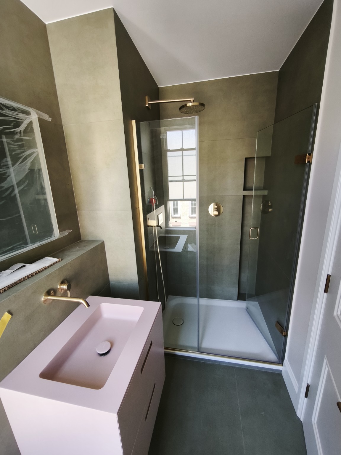 Green tiled bathroom with shower niche
