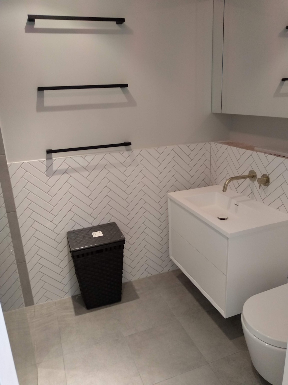 Finished white herringbone bathroom feature wall