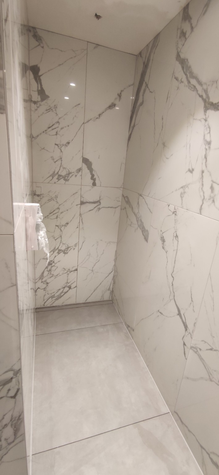 White marble-look porcelain shower